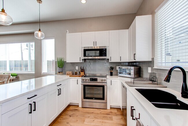 Kitchen with quartz countertop - 8500 W 62nd Ave