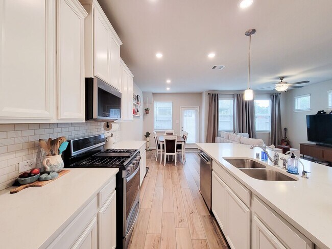 Building Photo - A true gem on a quiet corner lot, this spacious and sun-filled home is tucked away from street no...