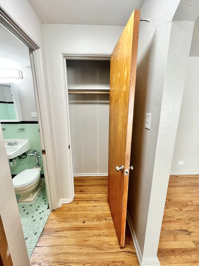 Experience the charm of this cozy area with a sleek bathroom and efficient closet design. - The Birney Apartments