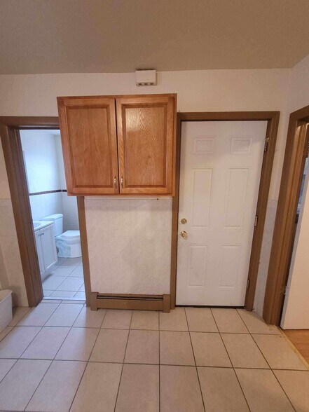 view from kitchen facing bathroom, backdoor for garbage, and bedroom 3 is to the right - 406 N 2nd St