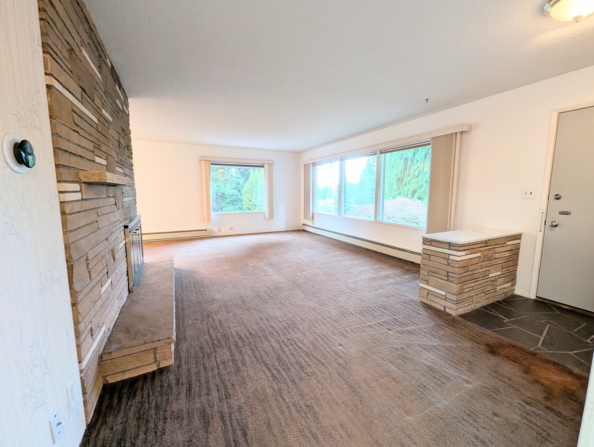 livingroom full of natural light from over size windows - 2575 Yew Street Rd