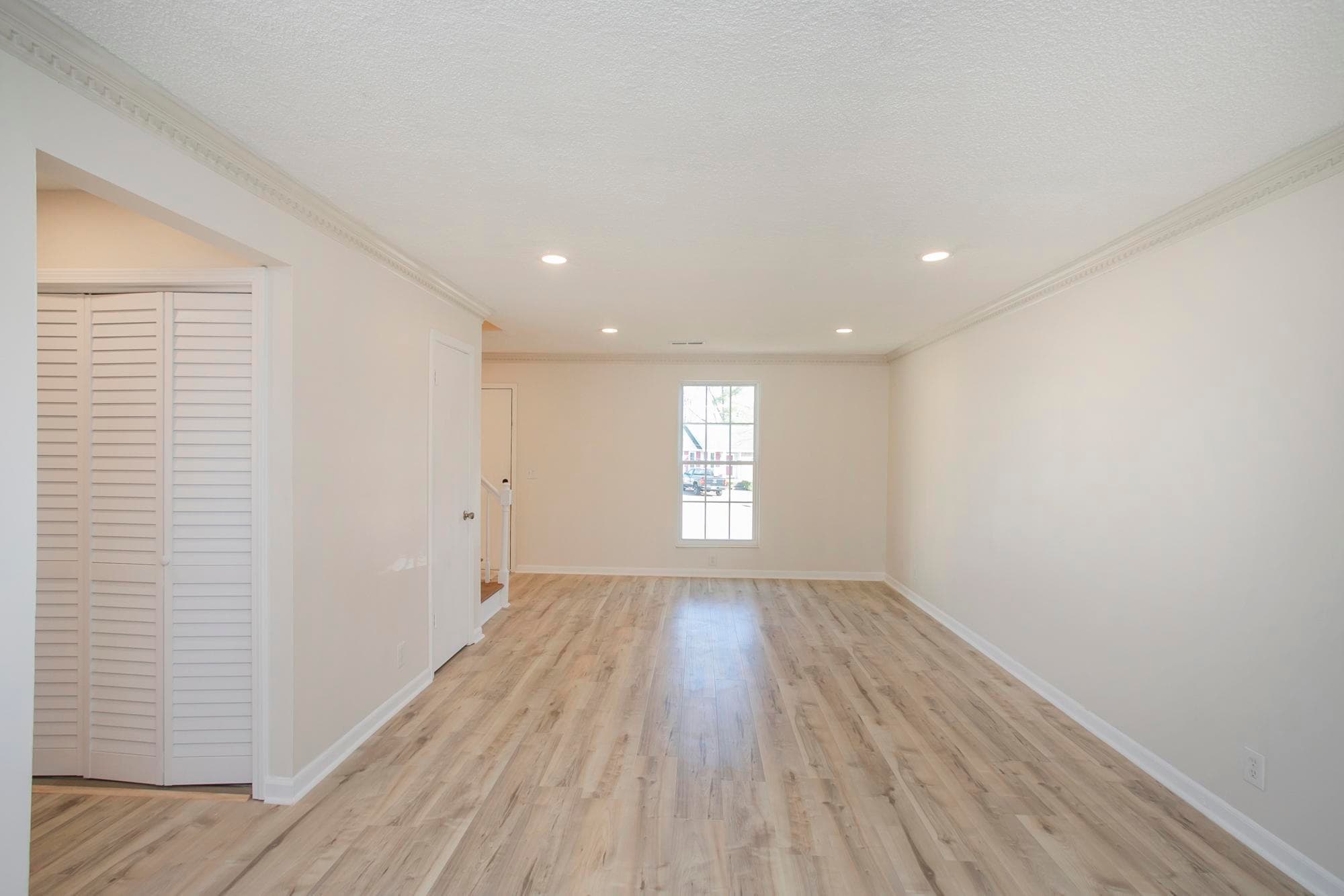 living room featuring beautiful wood flooring and abundant natural light. - 105 Jacksons Retreat Ct