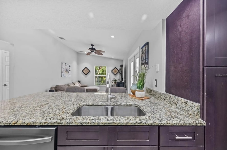 Open-concept layout connects kitchen and living areas for easy flow. - 1932 Brainerd Ct