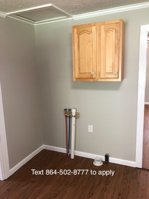 laundry hookups and cabinet in kitchen - 1910 Martin Ave