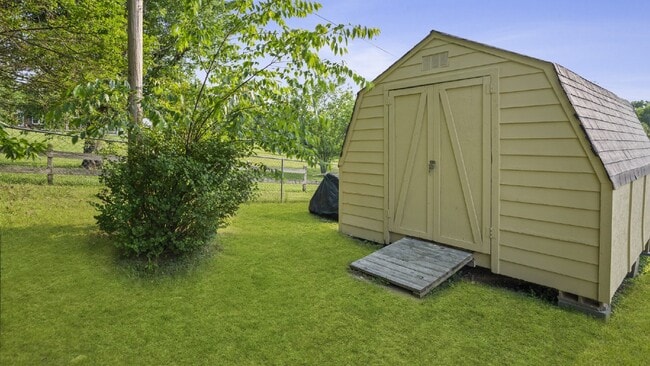 Building Photo - Now Ready : 4BR, 1 1/2BA home with fenced in back yard and storage building.