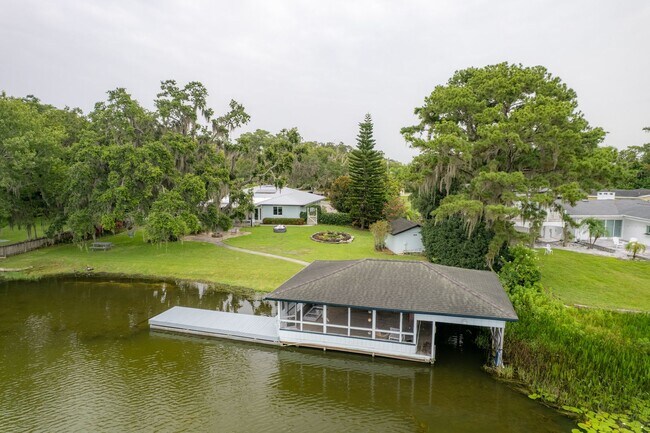 Building Photo - Lake Jessamine Luxury: Solar-Powered Waterfront Retreat on 1.14 Acres with Dock & Boathouse