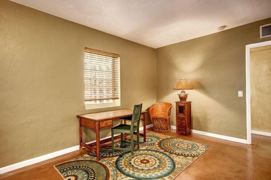 Large master bedroom with french doors to back patio. Enough room large bed and home office. NOTE: Furniture not included. Rented unfurnished. - 2648 E Drachman St