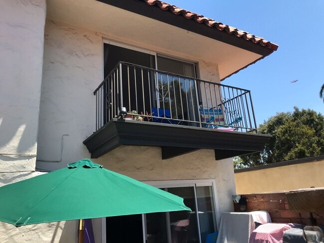 Building Photo - Beautiful Townhome with large fenced back patio, second story balcony, and two covered parking spots