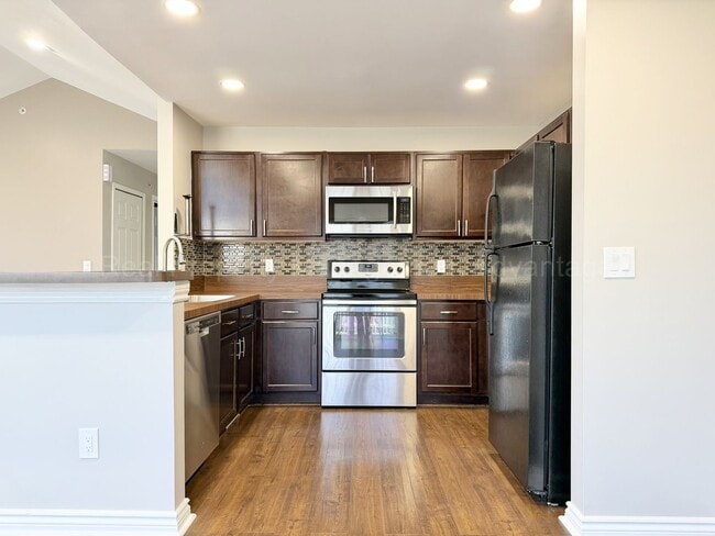 Building Photo - Rare Corner Upper Condo with Vaulted Ceilings, Private Balcony and 2 Car Garage - Right Across fr...