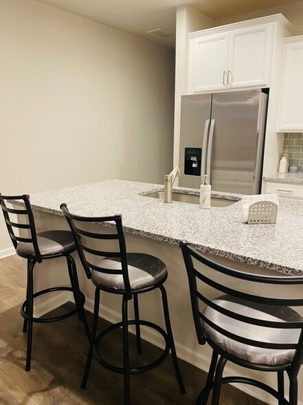 The kitchen island has satin barstools, comfortable for dining - 6126 Centennial Run