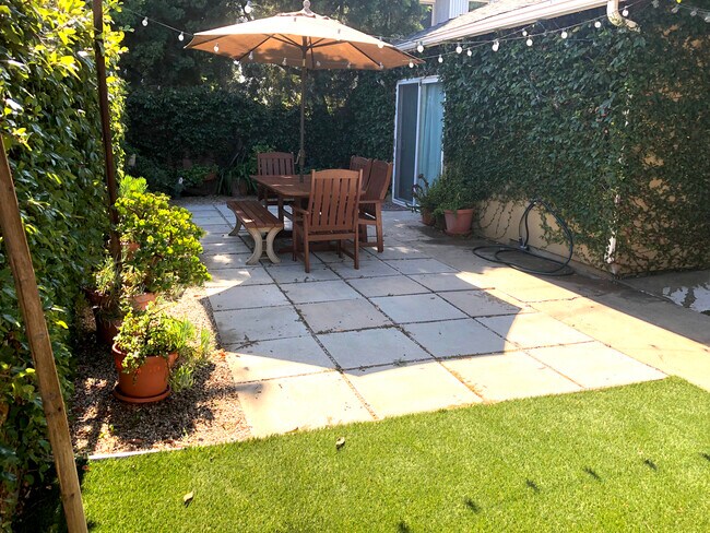 Outdoor dining under the umbrella - 4360 Stewart Ave