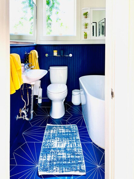 Upstairs bathroom has unique mid-century modern blue tile and a large, deep spa soaking tub. - 328 Harriet St