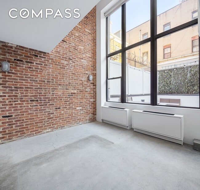 Building Photo - Loft-style one-bedroom with double-height ceilings, oversized windows, and private garden in the ...