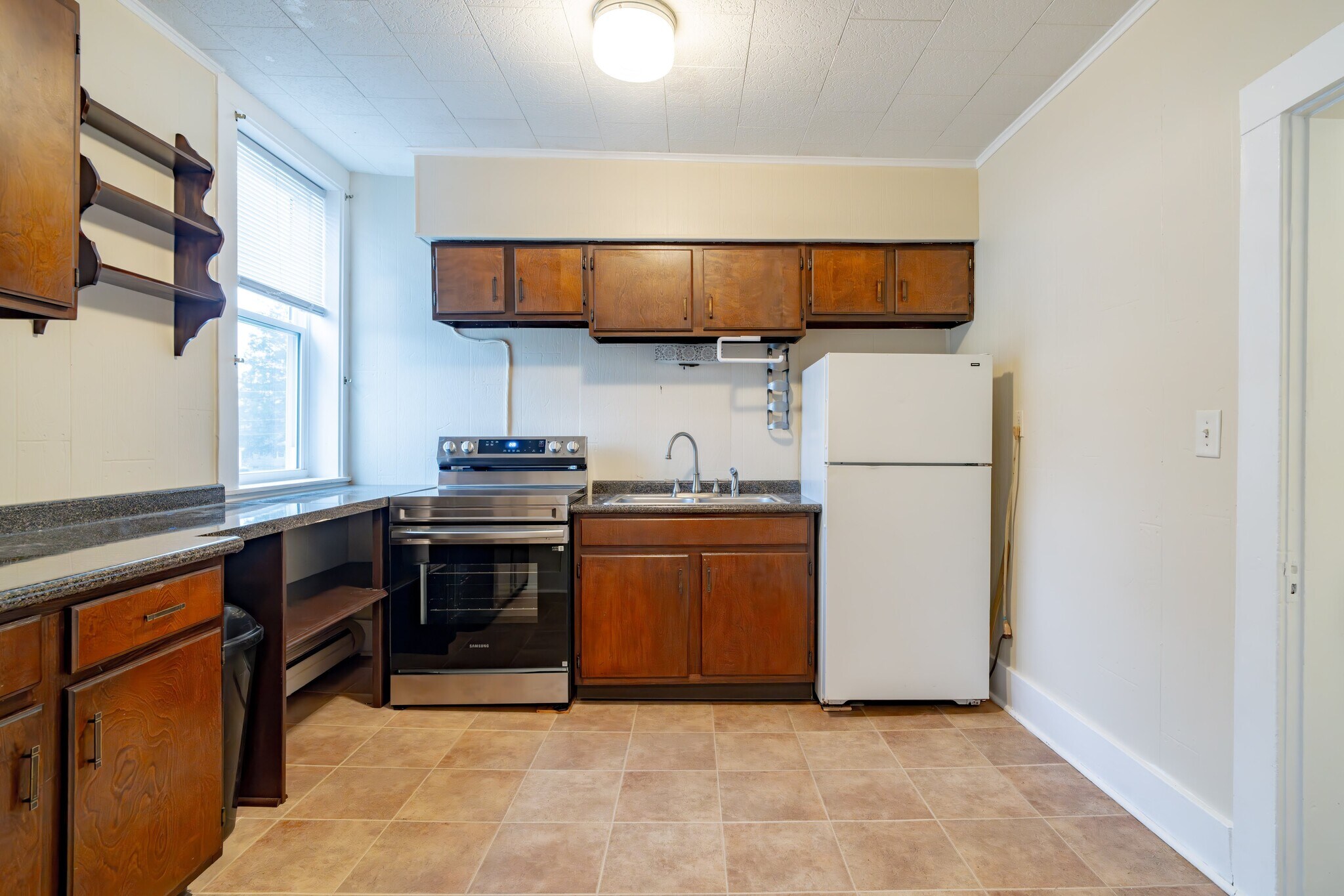 Kitchen with new counter, new range and refurbished cabinets - 100 N Main St