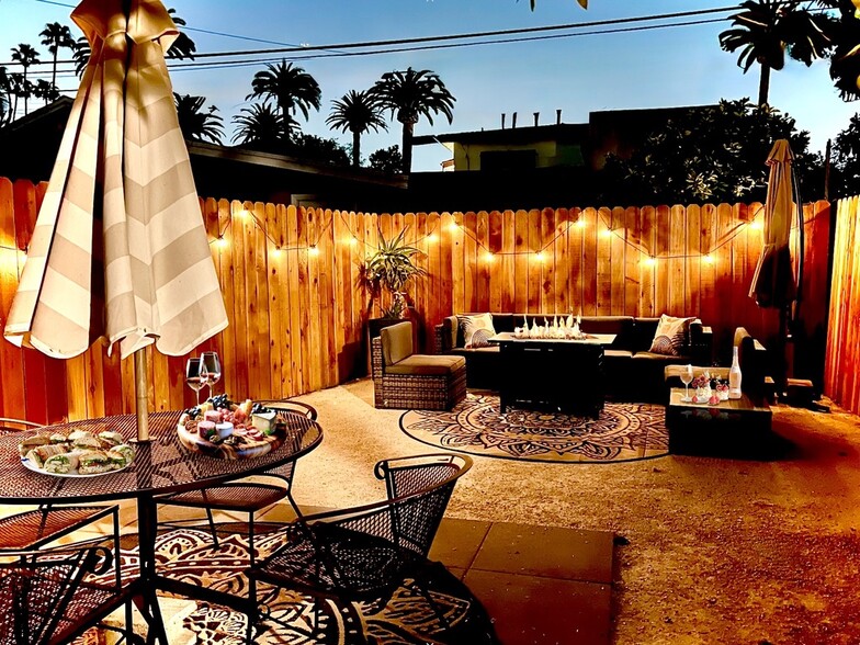Gather and relax around the fire pit table. - 2824 S Orange Dr