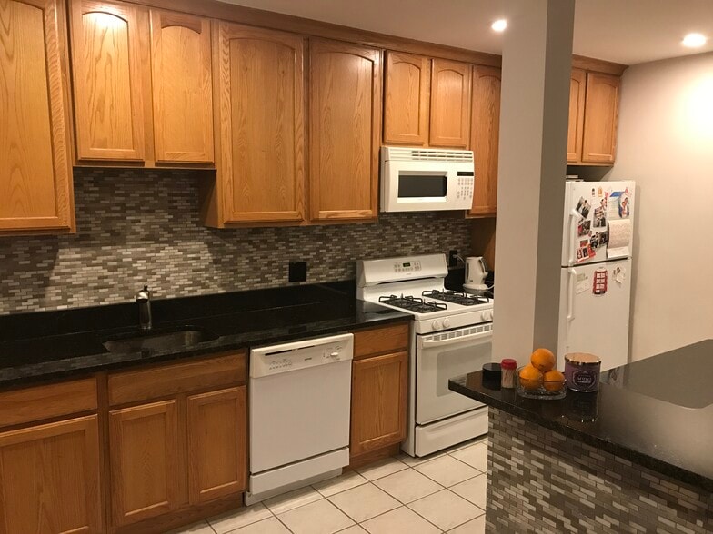 Open floor plan- furnished kitchen with cookware and silverware, furnished island with bar stools - 3719 12th St NE