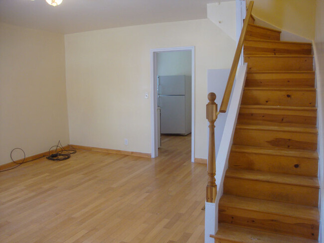 Living room looking toward the kitchen from front entry area. - 239 W Venango St