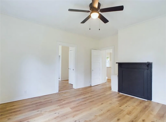 Living Room: A black accent mantle provides a stylish focal point for the room, ideal for gatherings - 1011 Elm St