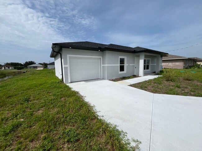 Building Photo - BRAND NEW MODERN SF HOME 3BD+den/2BA with GARAGE IN LEHIGH ACRES!