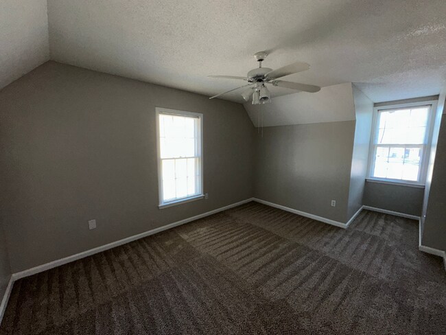 Building Photo - Charming 3BR/2BA Near Southwind | Hardwood Floors, Brick Fireplace, Bay Window & 2-Car Garage