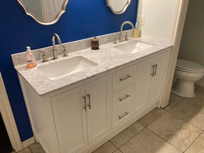 Double vanity sinks with plenty of storage space. - 16485 County Road 164