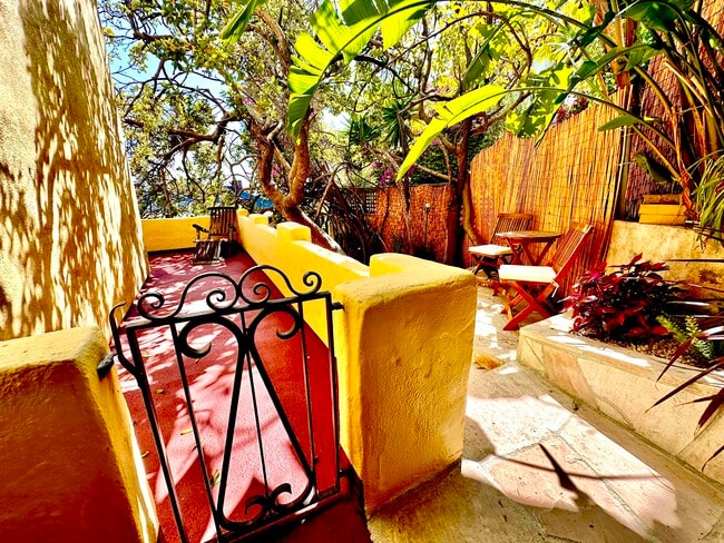 Side deck and flagstone terrace with table and chairs - 1760 N Fairfax Ave