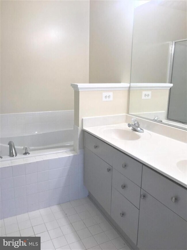 Building Photo - Welcome to this beautifully appointed two level upper condominium that combines modern style with...