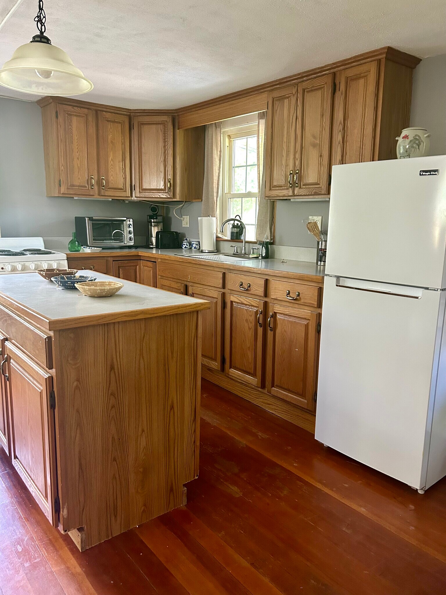 Kitchen island counter space, wooden cabinets and refrigerator - 32 Meadow St