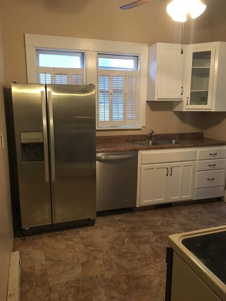 Spacious kitchen with modern amenities. New never used firdge and dishwasher. Sink features a garbage disposal. Cabinets have been repainted and new hardware, all functional. - 1545 S 13th St