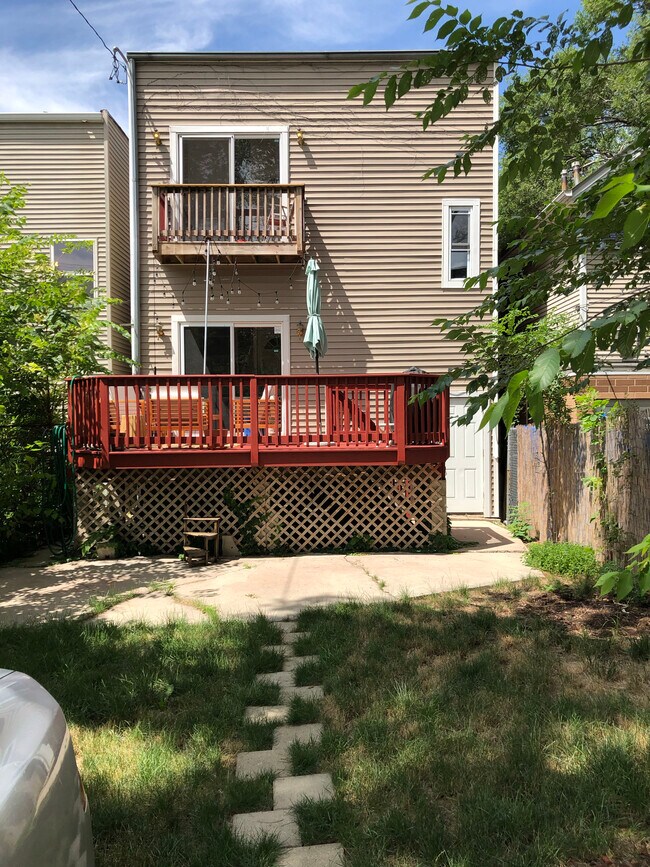 Backyard with private balcony and shared deck. - 1227 N Rockwell St