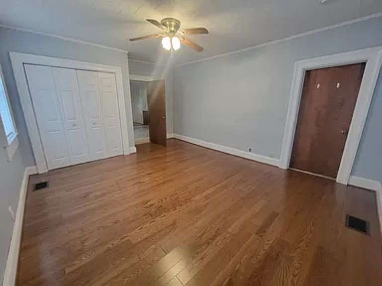 Bedrooms with hardwood floors and large closets - 16981 M-52
