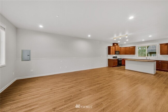 Living room & kitchen. Installed new floors. - 16439 77th Avenue Ct E