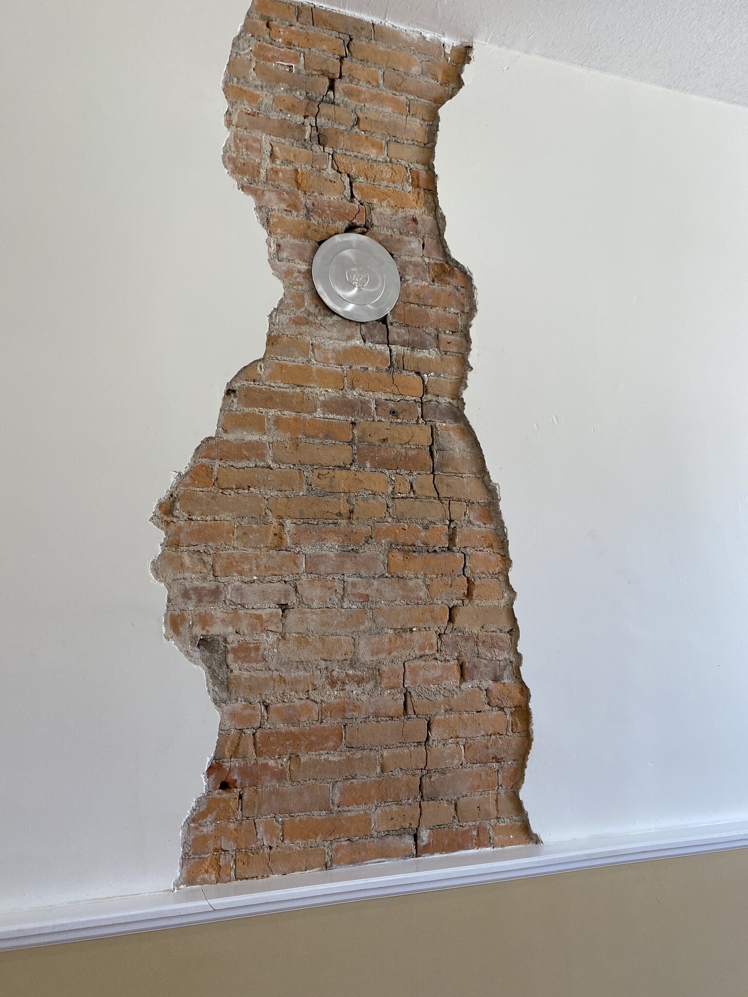 Original plaster with exposed brick. - 104 S Main