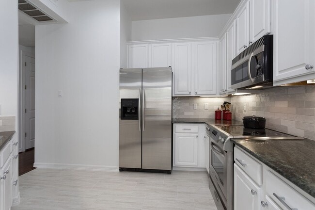 Building Photo - Gorgeous Mediterranean-style condo located...