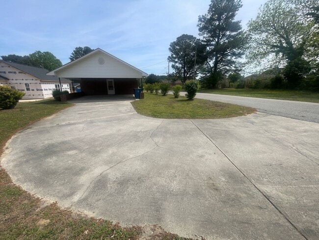 Building Photo - Brick Ranch- Dunn- 4 bedroom 2.5 bath- 2 car carport- Corner Lot