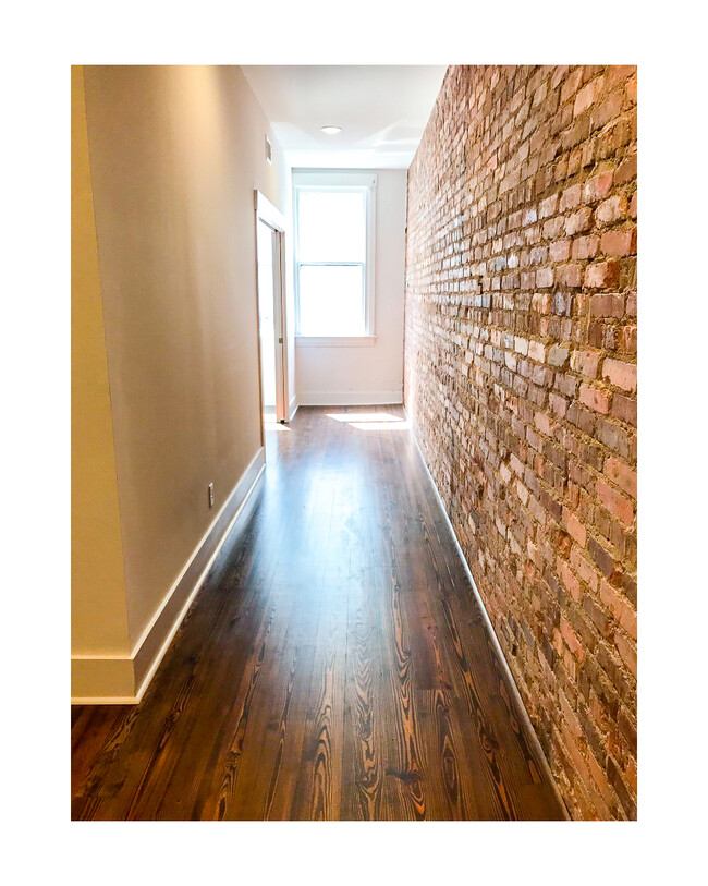 Walkway to the sliding partition doors and the window nook from the bedroom. - 18 W State St