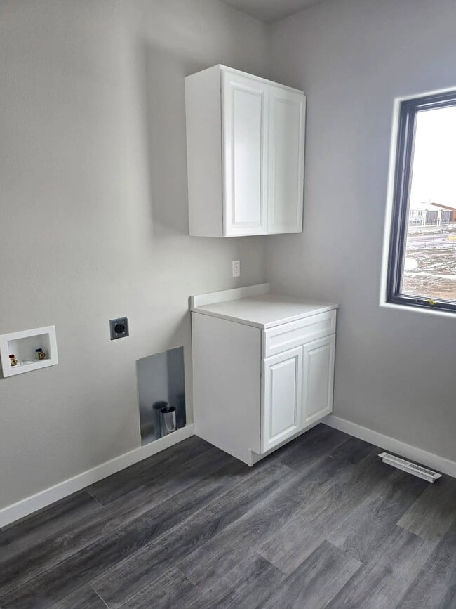 Welcome to Paradise Valley Townhomes, where modern design meets functionality. This stunning laundry space offers sleek cabinetry and abundant natural light, making chores a breeze. Schedule your tour today to see your new home! - Paradise Valley Townhomes & Apartments