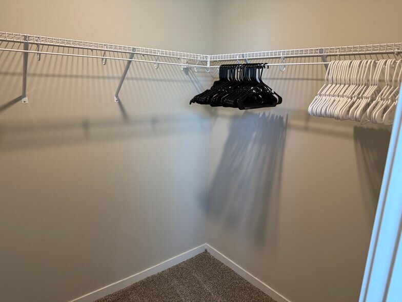 Master walk in closet with hangers - 4521 SE Ember Ln