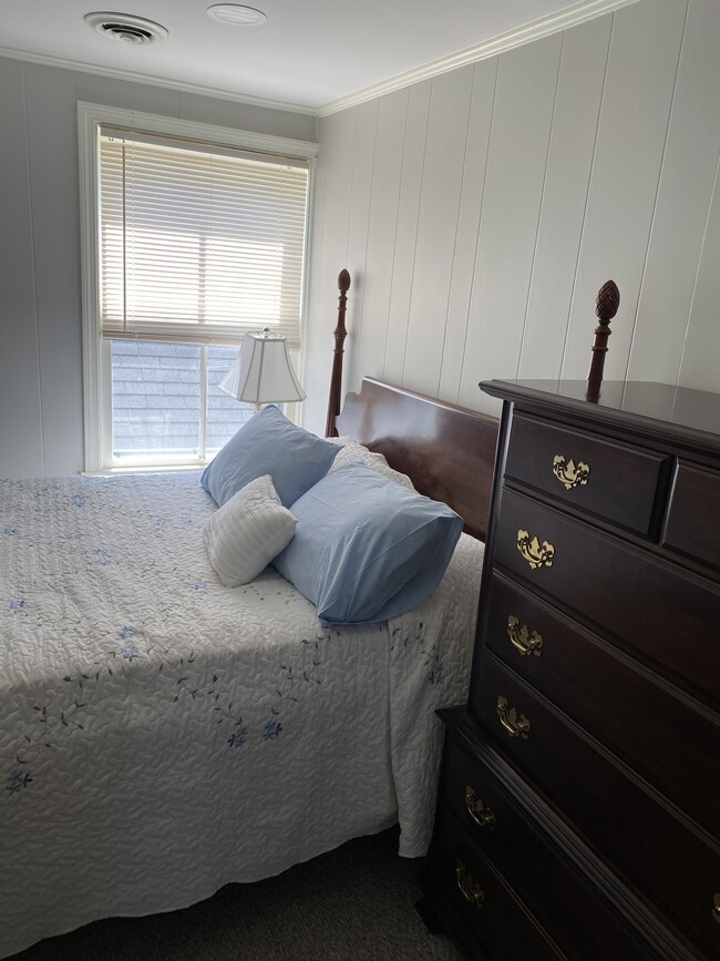 Bedroom #1 has a comfy leather chair and ottoman - 9 Everett St