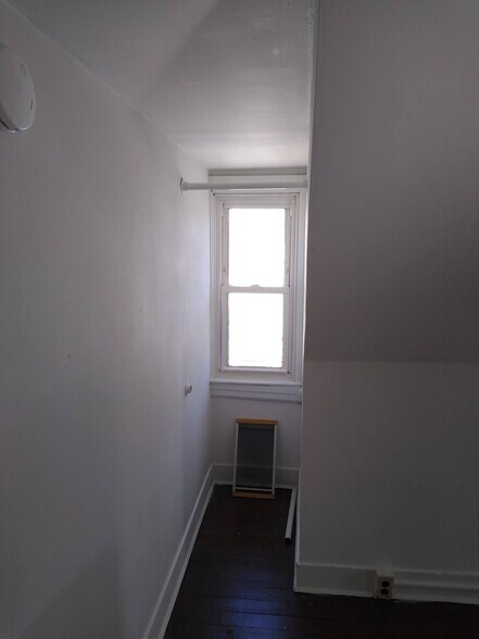 3rd FL Bonus Rm Storage clothing rods - 513 Hanover St