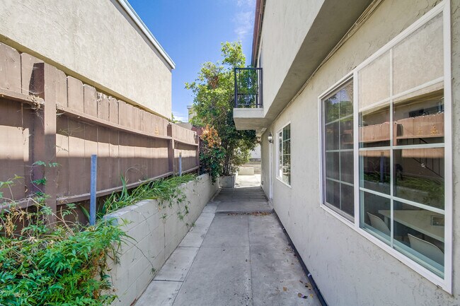 Just beyond the gate lies a peaceful pathway toward the fully fenced outdoor space. - 2304 E 14th St