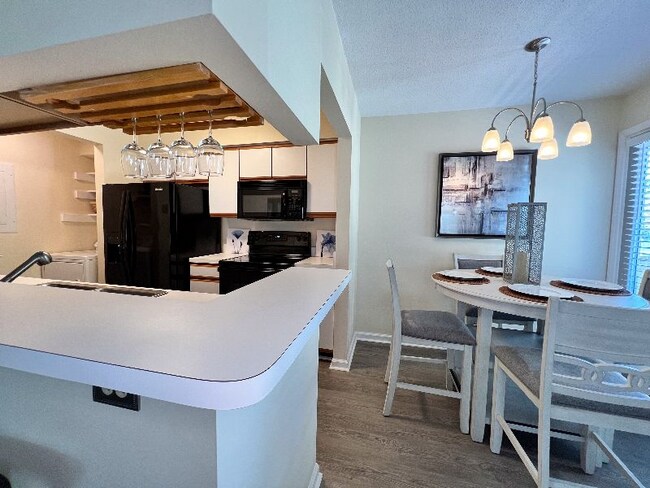 Kitchen and dining area view from living room. - 704 Rapidan River Ct