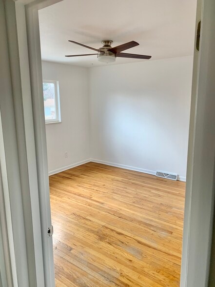 Up stairs bedroom with Hardwood floor and new fan, there are 3 bedrooms up they all look the same - 2709 Meadowlark Ave