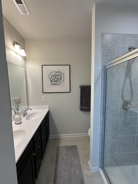 Master Bathroom with dual vanity and shower with bench - 4022 Edenborn Ln