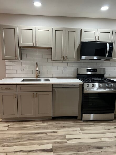 Gas range, dishwasher, and undermount sink, white subway tile backsplash - 408 John St