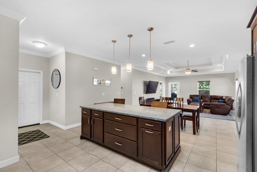 Open space for entertaining, with dining room table, island, and bar cart - 28 Snook Rd