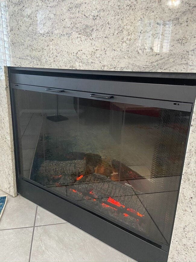 Building Photo - BEAUTIFUL CONDO IN A GATED COMMUNITY FEATURING PLANTATION SHUTTERS, TILE FLOORING AND NEW PAINT T...