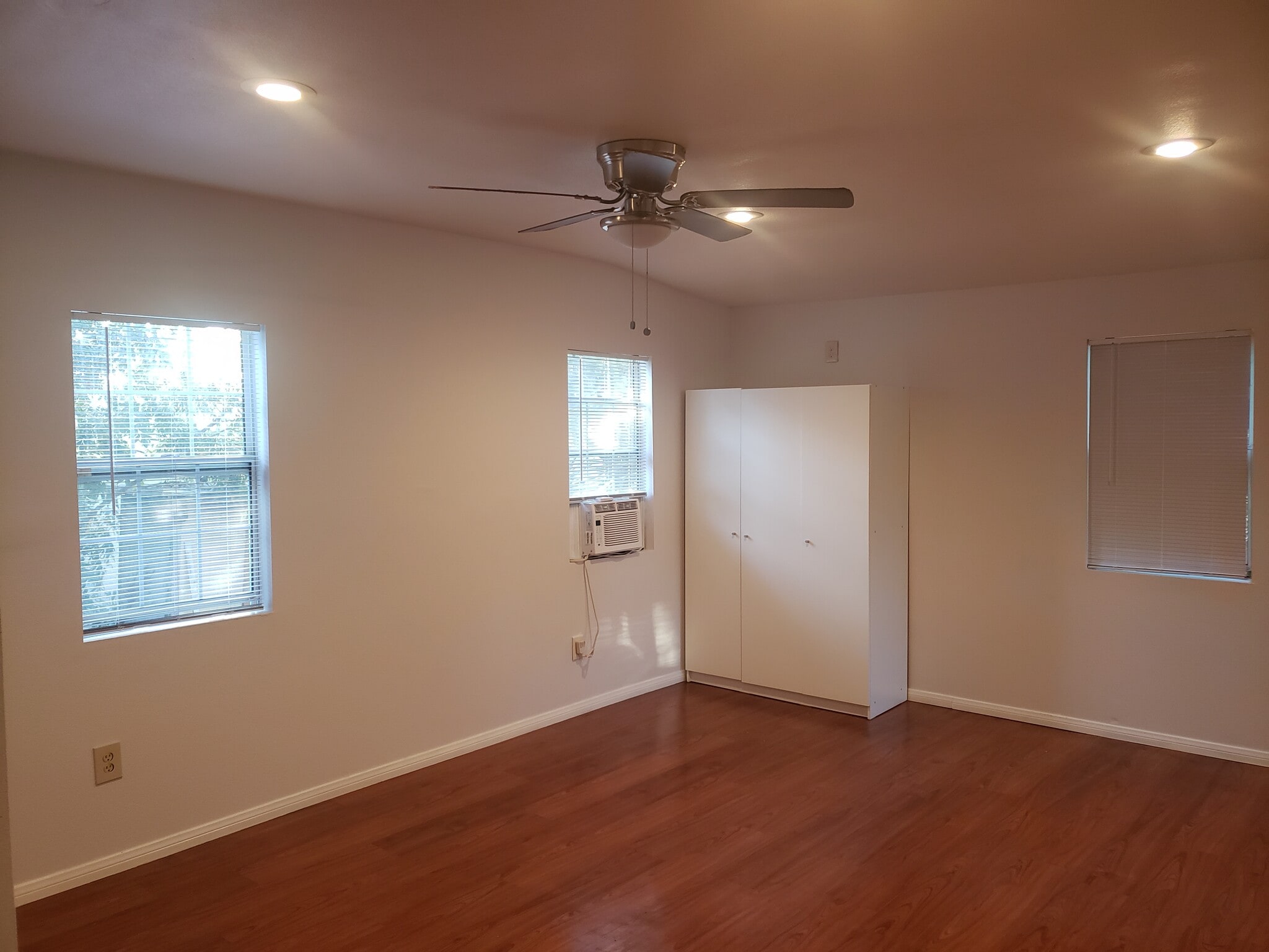Living space with wood-style flooring - 4966 Twining St