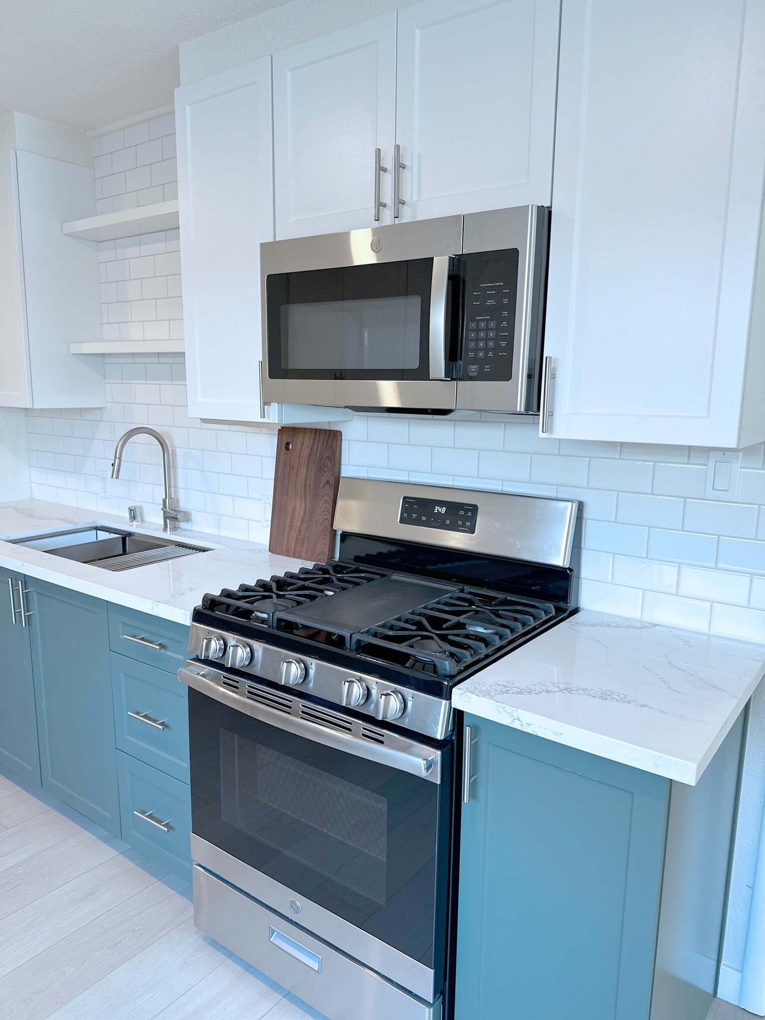Gas range and oven paired with a built-in microwave create a chef’s dream cooking setup. - 4570 58th St