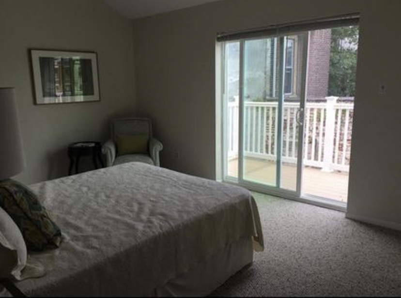 Bedroom with cathedral ceiling and sliding glass doors to private balcony deck - 821 N Taney St